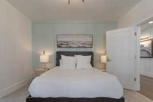 Bedroom featuring a decorative wall