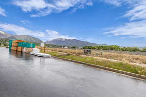 Water view featuring a mountain backdrop and a dock