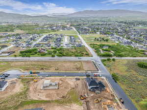 Aerial view of property and surrounding area featuring a mountain backdrop