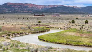View of mountain background with a large body of water and rural landscape