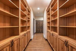 Spacious closet with light wood-style flooring