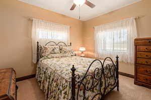 Bedroom featuring carpet flooring, baseboards, and a ceiling fan