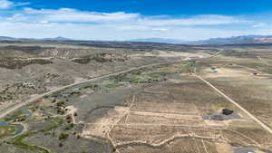 Overview of rural landscape with a desert landscape and a mountain backdrop