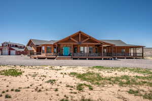 View of front of property with home and barn