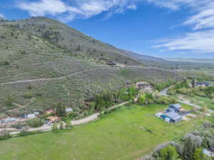 Aerial view of property and surrounding area featuring mountains