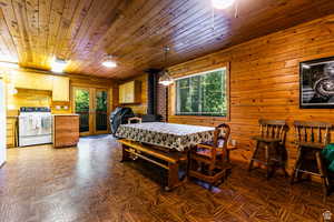 Dining room with wooden walls, wooden ceiling, and french doors