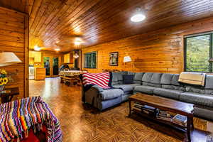 Living room with wooden ceiling and wooden walls