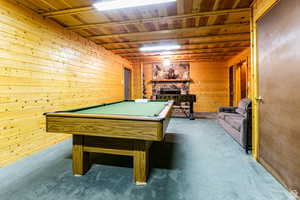 Recreation room with carpet flooring, billiards, wood ceiling, and wood walls