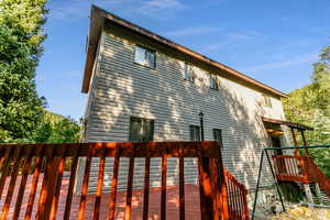 Rear view of property featuring a deck