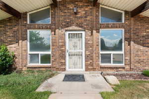 Property entrance featuring brick siding