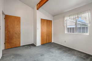 Unfurnished bedroom featuring carpet flooring, baseboards, and a closet