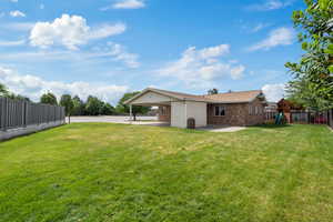 View of yard with a playground, an attached carport, and concrete driveway