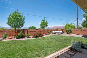 View of yard with an outdoor living space and a mountain view