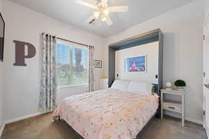 Carpeted bedroom with baseboards and ceiling fan