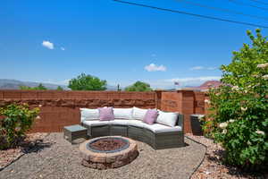 View of patio / terrace featuring a fire pit, fence, and a mountain view