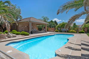 Community pool featuring a patio, fence, and a gazebo