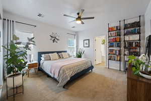 Bedroom featuring light colored carpet and baseboards