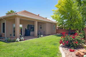 Back of house with stucco siding, a patio, and a tiled roof