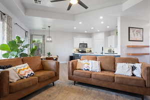 Living room featuring light wood-style floors, recessed lighting, baseboards, and a ceiling fan