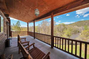 Wooden deck with a mountain view and a forest view