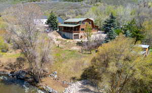 Aerial view of property and surrounding area with a heavily wooded area
