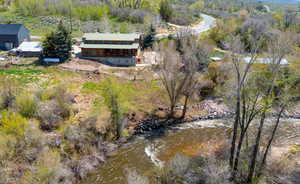 View from above of property featuring a heavily wooded area