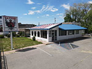 View of building exterior with uncovered parking