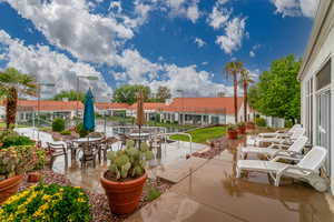 View of patio featuring fence