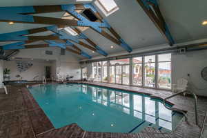 Indoor pool featuring a skylight