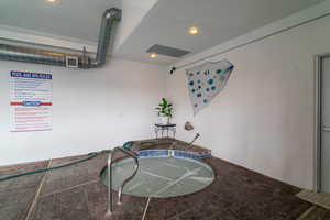 Misc room featuring stone finish flooring and recessed lighting