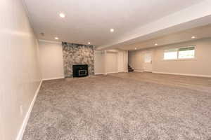Unfurnished living room featuring carpet floors, stairway, recessed lighting, and baseboards
