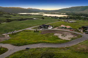 Aerial overview of property's location featuring a mountain backdrop and rural landscape