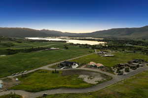 Aerial view of property and surrounding area featuring a water and mountain view
