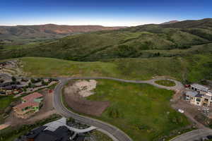 Aerial view of property's location with a mountainous background