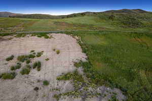 Aerial overview of property's location with a mountainous background and rural landscape