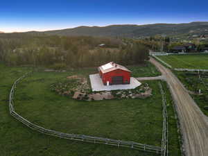 Aerial view of property's location with rural landscape and mountains