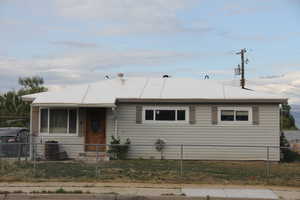 Single story home with a fenced front yard