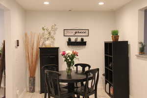 Dining space with recessed lighting and light tile patterned floors