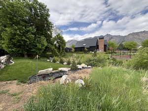 View of yard with a mountain view and fence