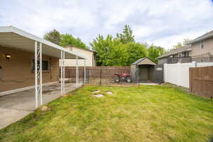 View of yard with a storage unit and an outdoor structure