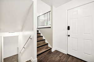 Stairs featuring wood finished floors and baseboards