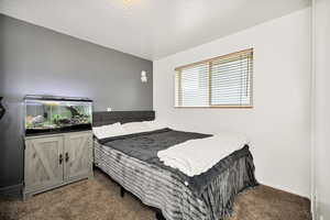 Carpeted bedroom featuring baseboards