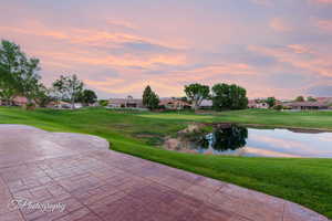 View of patio featuring a residential view, a water view, and view of golf course
