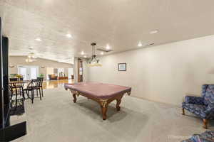 Game room featuring lofted ceiling, billiards, a textured ceiling, recessed lighting, and ceiling fan