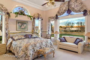 Carpeted bedroom with crown molding and ceiling fan