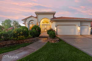 Mediterranean / spanish house featuring an attached garage, a tiled roof, concrete driveway, and stucco siding