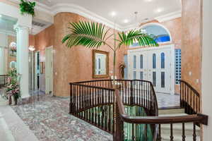 View of exterior entry featuring stucco siding and covered porch