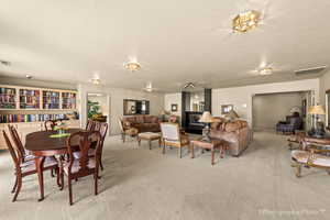 Dining space with carpet floors and a textured ceiling