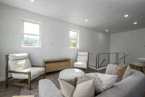 Sitting room with wood finished floors, baseboards, and recessed lighting
