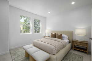 Bedroom with light colored carpet, baseboards, and recessed lighting